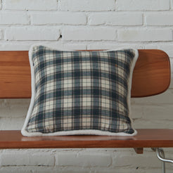 Ivory and navy tartan woven cotton-polyester blend square pillow cover on a bed