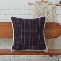 Navy and red tartan woven cotton-polyester blend square pillow cover on a bed