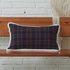 Navy and red tartan woven cotton-polyester blend lumbar pillow cover on a bed