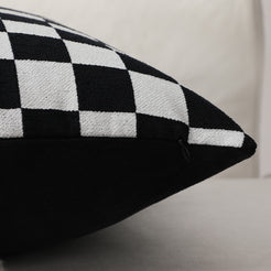 Side view of a black checkerboard chenille pillow cover with hidden zipper