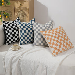 Black, blue, gray and orange checkerboard chenille pillow covers on a sofa