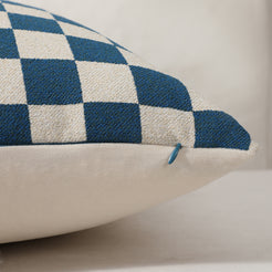 Side view of a blue checkerboard chenille pillow cover with hidden zipper