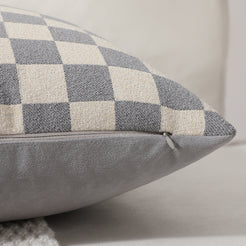 Side view of a gray checkerboard chenille pillow cover with hidden zipper
