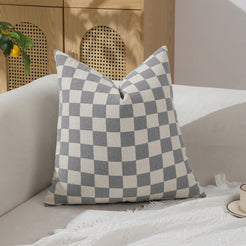 Gray and ivory checkerboard chenille square pillow cover on a sofa