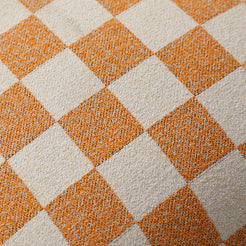 Close-up of orange and ivory checkerboard chenille texture