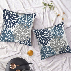Set of two water-resistant pillow covers with navy and gray chrysanthemum pattern, styled on a bed