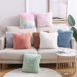 Faux-fur plush polyester pillow covers with pastel and neutral colors with long-pile texture, styled on a cream sofa