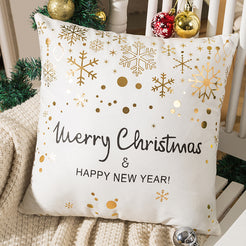 short-pile plush polyester pillow cover with Merry Christmas lettering with gold snowflakes, shown beside a Christmas tree