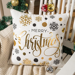 short-pile plush polyester pillow cover with script Christmas lettering and gold ornaments, shown beside a Christmas tree