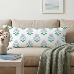 Long lumbar pillow cover with lavender-blue small floral sprigs, styled on a cream sofa