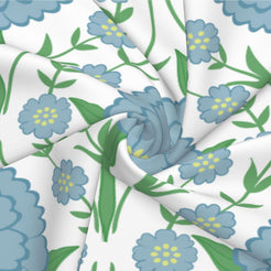 Fabric close-up of long lumbar pillow cover with blue medallion flowers and green vines