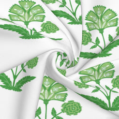 Fabric close-up of long lumbar pillow cover with green block-print-inspired floral sprigs