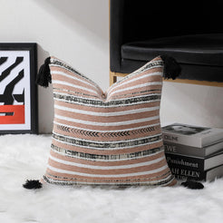 Blush, ivory and black striped chenille-textured polyester square pillow cover in a room setting