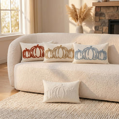 Tufted polyester pillow covers with outline pumpkin covers in square and lumbar shapes, grouped on a cream sofa