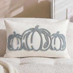 Tufted polyester pillow cover with pale blue outline pumpkins on a lumbar cover, shown on a cream chair