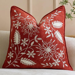 Red embroidered chenille-textured polyester square pillow cover with dense floral vines