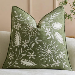Green embroidered chenille-textured polyester square pillow cover with dense floral vines
