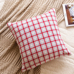 Woven polyester pillow cover with red and white small check, styled on a blanket