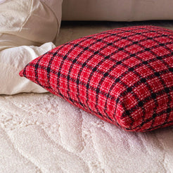 Hidden zipper and fabric close-up on woven polyester pillow cover with red and black textured plaid