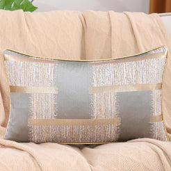 Silver gray and gold jacquard-woven polyester lumbar pillow cover styled on a sofa