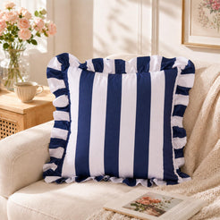 White and navy striped velvet polyester pillow covers with ruffled edges, styled as a single cover